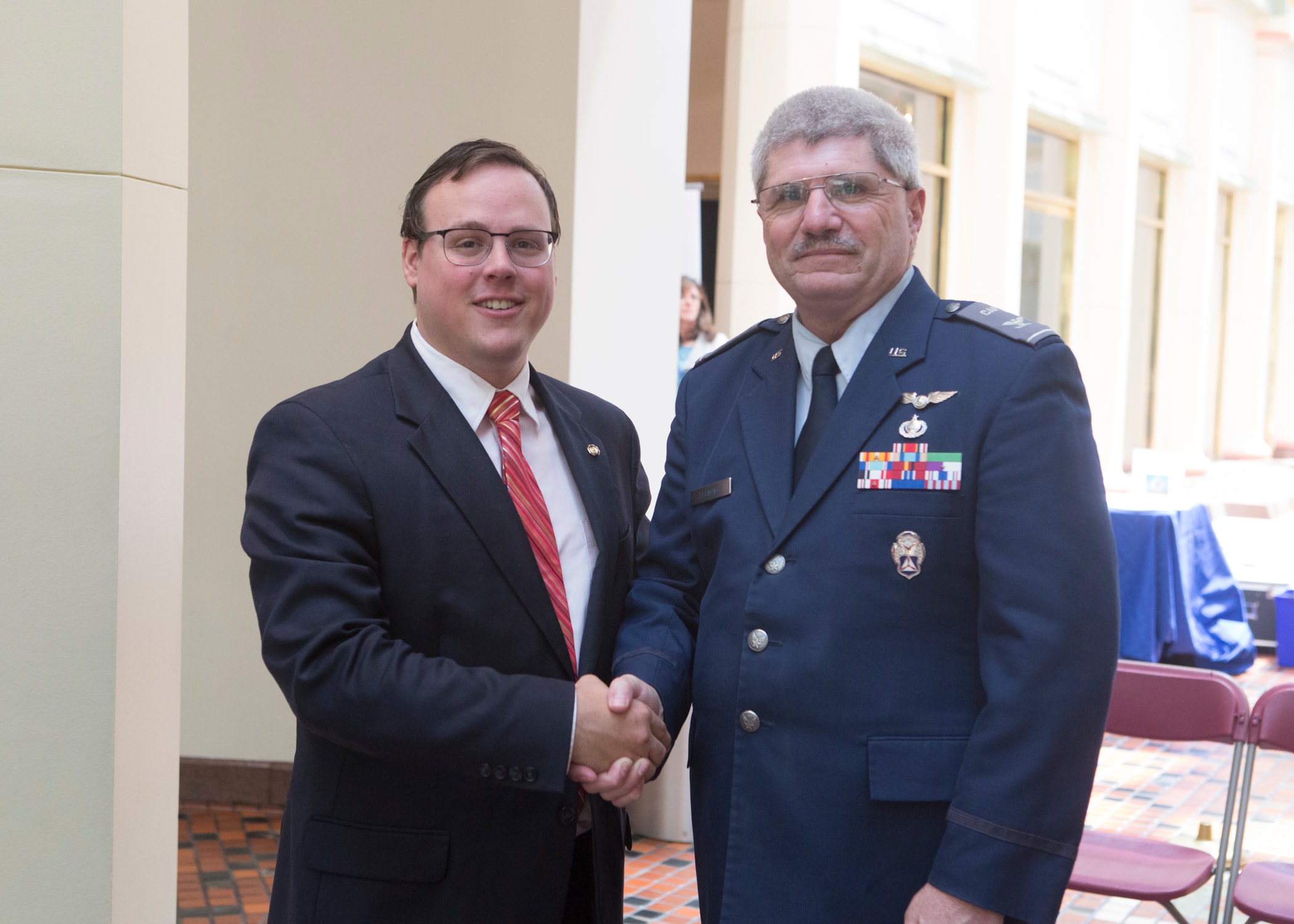 Rep. Dowling shakes hands with a senior Air Force officer after the ceremony